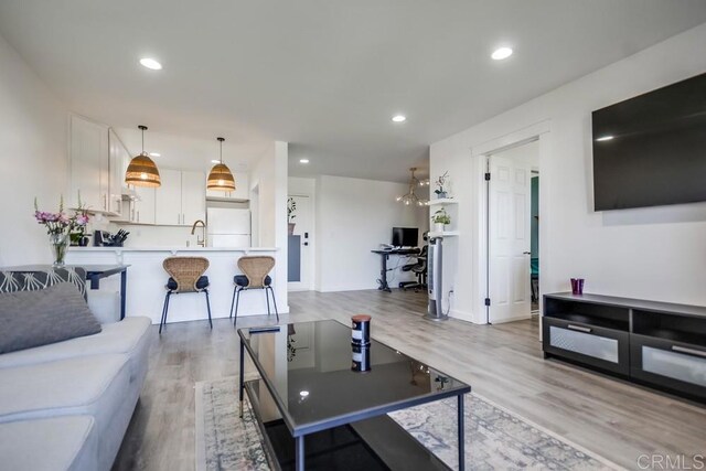6930 Hyde Park Dr Unit 218, San Diego, CA 92119 - living area with light wood finished floors, recessed lighting, and a desk