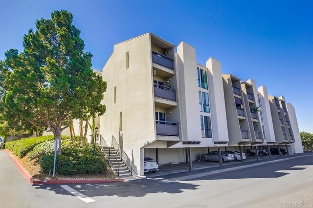 6930 Hyde Park Dr Unit 218, San Diego, CA 92119 - view of apartment building / complex with covered parking and stairs