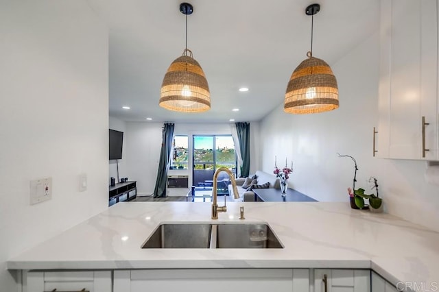 6930 Hyde Park Dr Unit 218, San Diego, CA 92119 - kitchen featuring a sink, open floor plan, white cabinets, hanging light fixtures, and recessed lighting