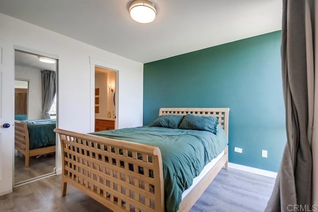 6930 Hyde Park Dr Unit 218, San Diego, CA 92119 - bedroom with wood finished floors, baseboards, and connected bathroom