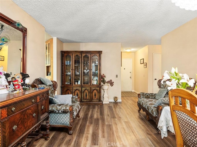 3038 Blakeman Ave, Rowland Heights, CA 91748 - living area with wood finished floors, a textured ceiling, and baseboards