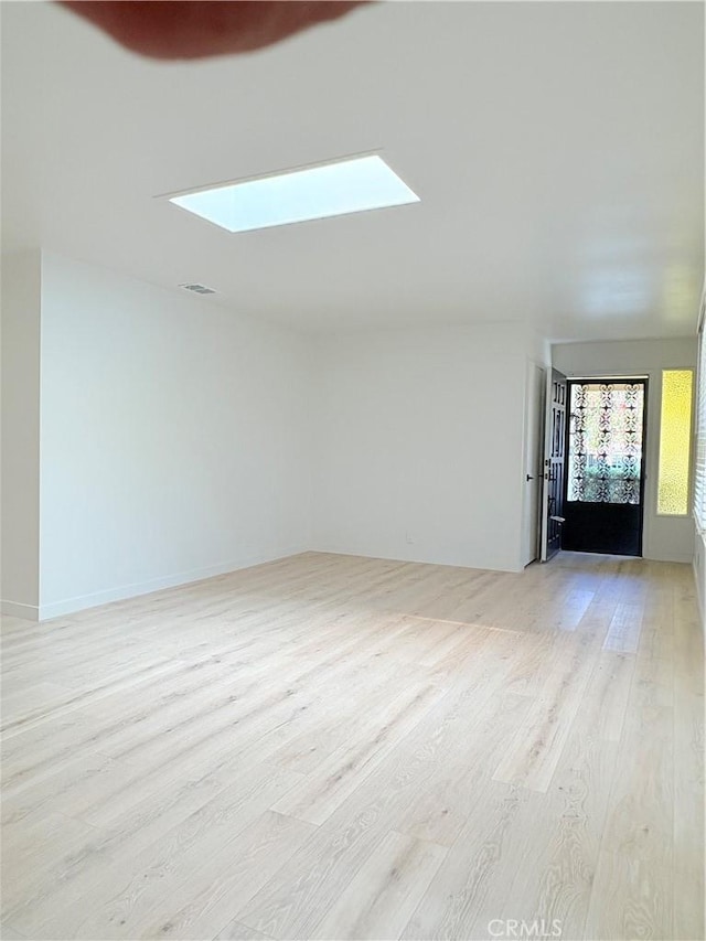3088 Via Serena N Unit D, Laguna Woods, CA 92637 - unfurnished living room featuring a skylight and light wood-type flooring