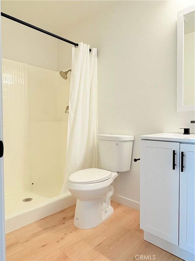 3088 Via Serena N Unit D, Laguna Woods, CA 92637 - full bath featuring wood finished floors, toilet, vanity, and a shower with curtain