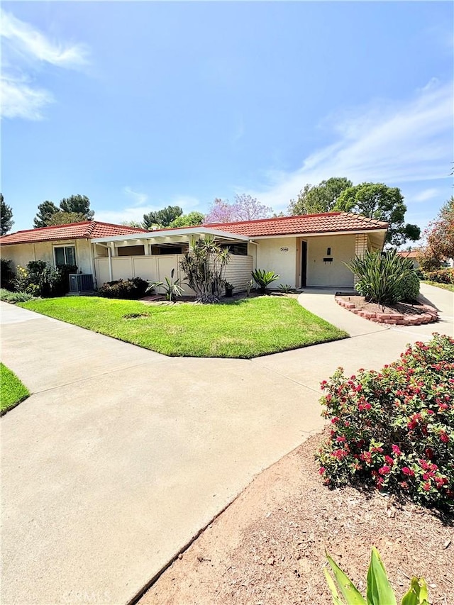 3088 Via Serena N Unit D, Laguna Woods, CA 92637 - ranch-style house with a tiled roof, a front lawn, and stucco siding