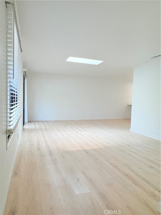 3088 Via Serena N Unit D, Laguna Woods, CA 92637 - spare room with wood finished floors, a skylight, and baseboards