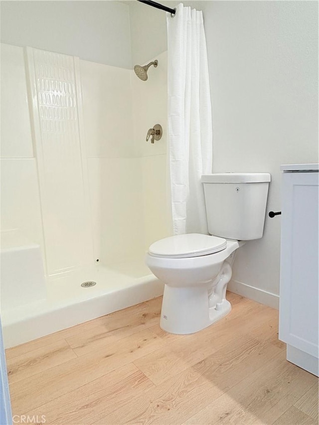 3088 Via Serena N Unit D, Laguna Woods, CA 92637 - full bathroom with wood finished floors, toilet, curtained shower, and baseboards