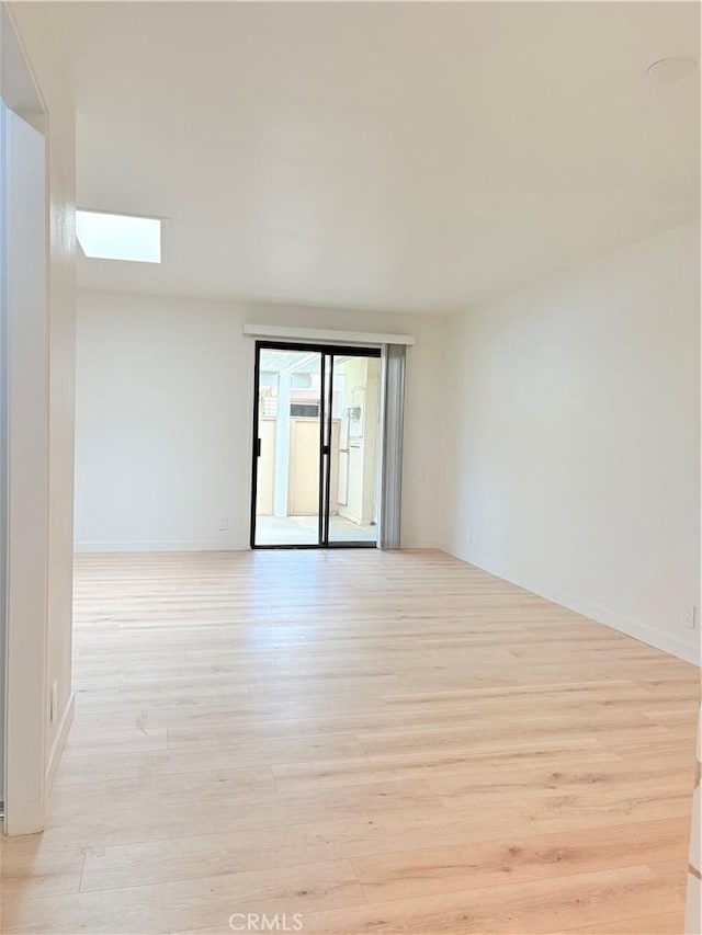 3088 Via Serena N Unit D, Laguna Woods, CA 92637 - empty room featuring light wood-style flooring, a skylight, and baseboards