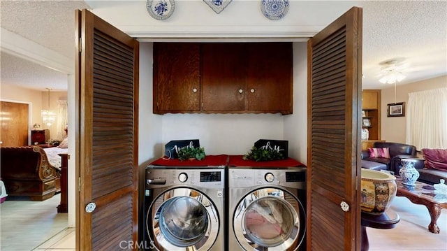 13424 Washington Ave, Hawthorne, CA 90250 - laundry room with a textured ceiling, wood finished floors, washing machine and clothes dryer, cabinet space, and ceiling fan