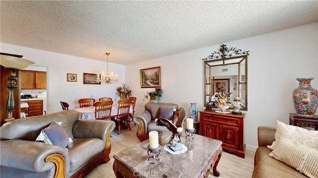 13424 Washington Ave, Hawthorne, CA 90250 - living room featuring a chandelier, light wood-style floors, and a textured ceiling