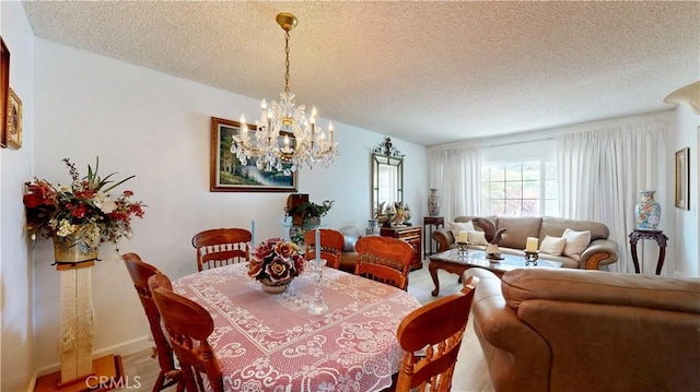 13424 Washington Ave, Hawthorne, CA 90250 - dining space featuring a chandelier, a textured ceiling, and wood finished floors