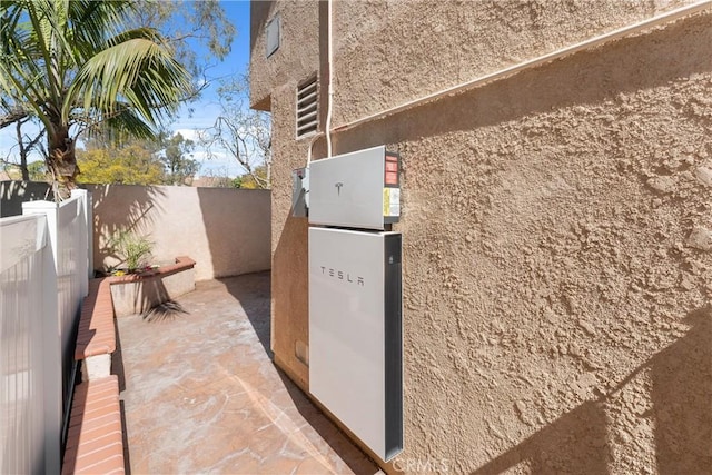 7 Monticello Ln, Rancho Santa Margarita, CA 92688 - exterior view of stucco siding and wall-mounted power storage