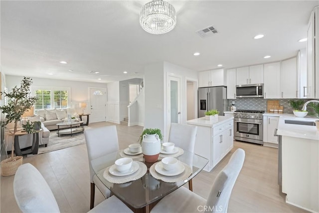 7 Monticello Ln, Rancho Santa Margarita, CA 92688 - dining space featuring light wood-style flooring, stairway, recessed lighting, and a chandelier