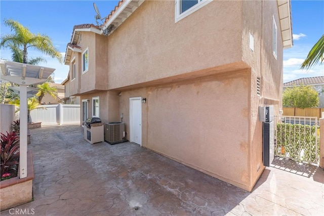 7 Monticello Ln, Rancho Santa Margarita, CA 92688 - view of property exterior featuring stucco siding, a patio area, and central AC