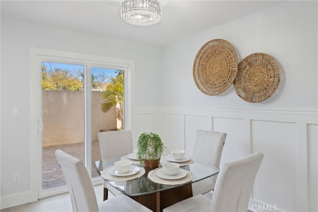 7 Monticello Ln, Rancho Santa Margarita, CA 92688 - dining space with a decorative wall, a wainscoted wall, a chandelier, and light tile patterned flooring