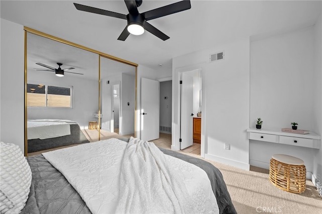 1086 Amacayo Ct, San Diego, CA 92154 - bedroom with a closet, baseboards, a ceiling fan, light carpet, and connected bathroom