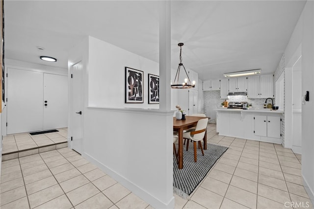 1086 Amacayo Ct, San Diego, CA 92154 - kitchen featuring light tile patterned floors, light countertops, a chandelier, a peninsula, and stainless steel range oven