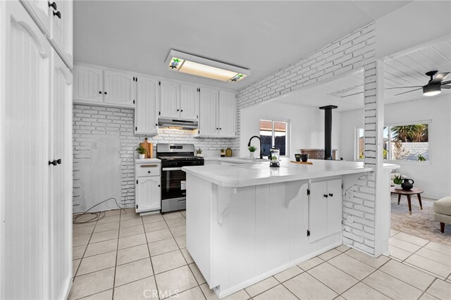 1086 Amacayo Ct, San Diego, CA 92154 - kitchen featuring stainless steel gas stove, light tile patterned floors, light countertops, and a sink