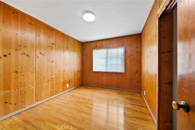 2034 W 165th St, Torrance, CA 90504 - spare room featuring light wood-style flooring, wooden walls, and baseboards