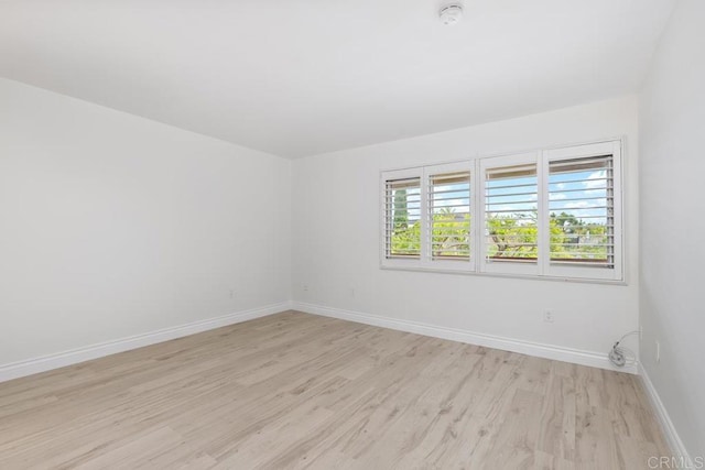 6808 Hyde Park Dr, San Diego, CA 92119 - empty room with light wood finished floors, a smoke detector, and baseboards