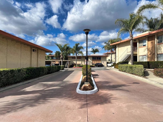 6808 Hyde Park Dr, San Diego, CA 92119 - view of concrete road featuring street lights, curbs, and stairs