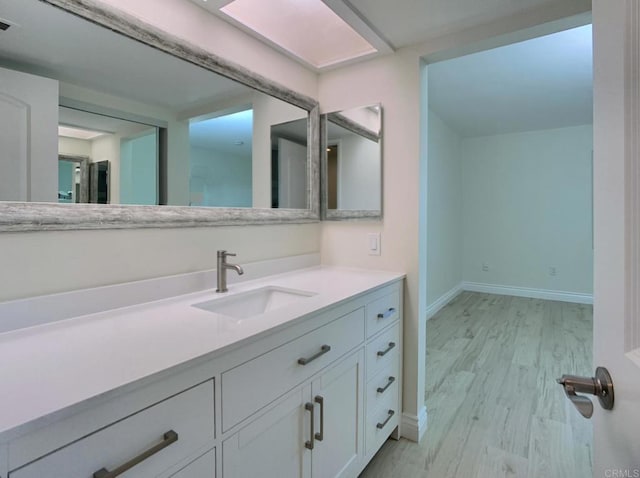 6808 Hyde Park Dr, San Diego, CA 92119 - bathroom featuring baseboards, wood finished floors, and vanity