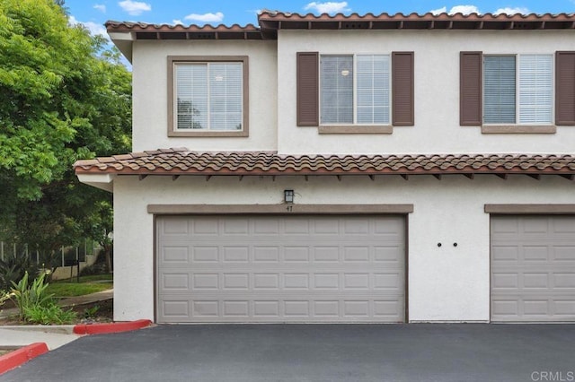 5529 Old Ranch Rd Unit 47, Oceanside, CA 92057 - view of front of house featuring an attached garage, driveway, and stucco siding