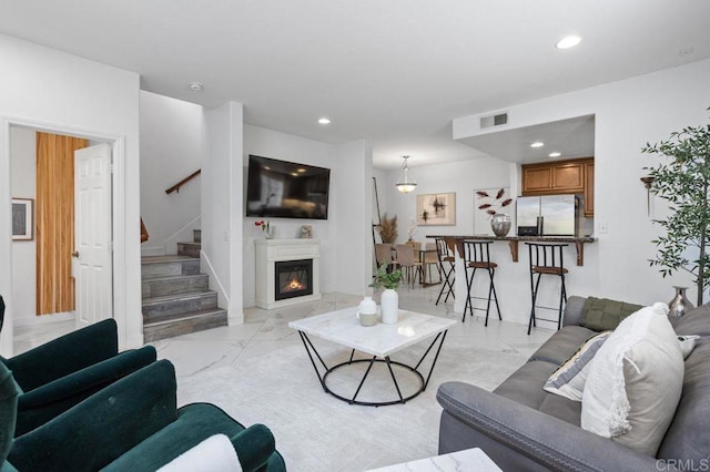 5529 Old Ranch Rd Unit 47, Oceanside, CA 92057 - living area with light marble finish flooring, stairs, recessed lighting, and a glass covered fireplace