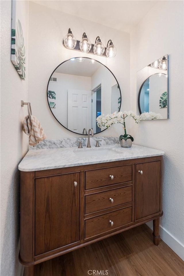 414 E Clarion Dr, Carson, CA 90745 - bathroom featuring wood finished floors, vanity, and baseboards