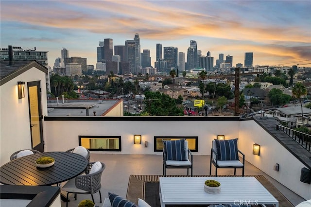 957 Everett St, Los Angeles, CA 90026 - patio terrace at dusk with a view of skyline and outdoor dining space