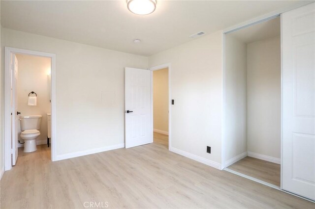18479 Aguiro St, Rowland Heights, CA 91748 - unfurnished bedroom with light wood-style flooring, baseboards, and connected bathroom