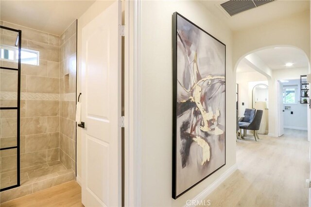 18479 Aguiro St, Rowland Heights, CA 91748 - hall with arched walkways and light wood-type flooring