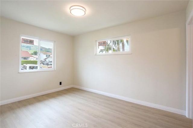 18479 Aguiro St, Rowland Heights, CA 91748 - unfurnished room with light wood-style floors, healthy amount of natural light, and baseboards