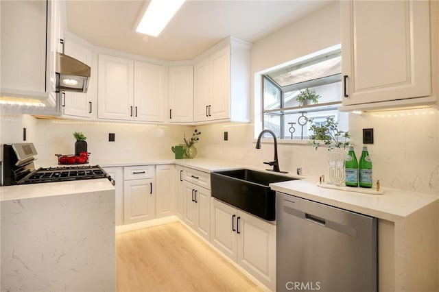 18479 Aguiro St, Rowland Heights, CA 91748 - kitchen with stainless steel appliances, a sink, premium range hood, light wood finished floors, and white cabinetry