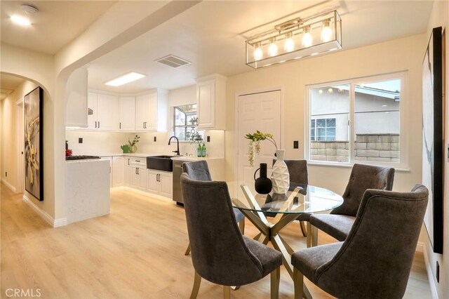 18479 Aguiro St, Rowland Heights, CA 91748 - dining space featuring light wood-style flooring and arched walkways