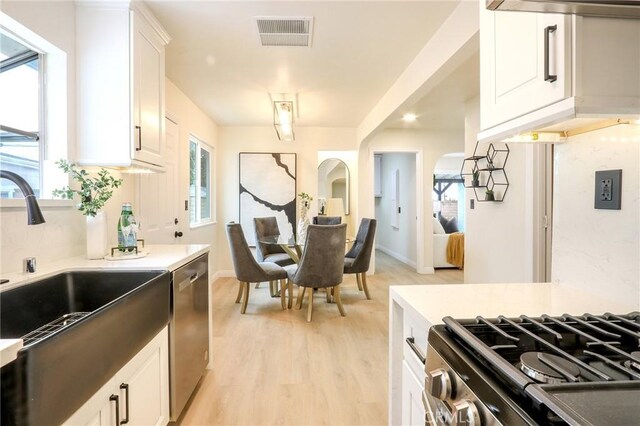 18479 Aguiro St, Rowland Heights, CA 91748 - kitchen featuring dishwasher, a sink, light wood finished floors, range with gas stovetop, and white cabinetry