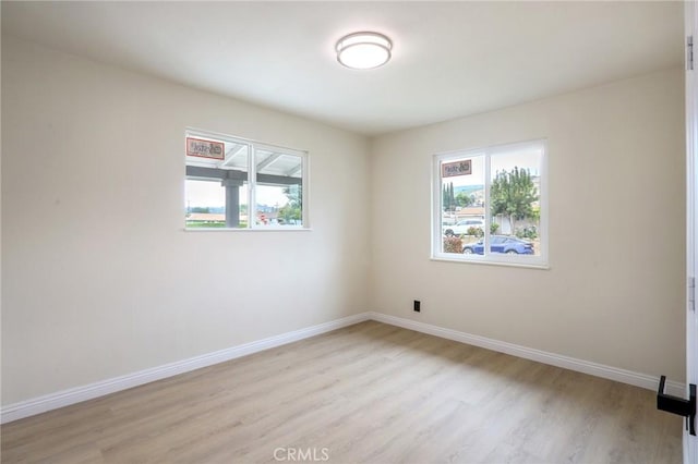 18479 Aguiro St, Rowland Heights, CA 91748 - empty room with healthy amount of natural light, light wood-type flooring, and baseboards
