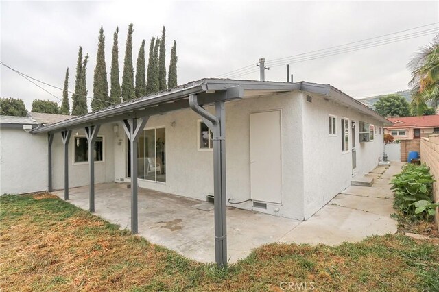 18479 Aguiro St, Rowland Heights, CA 91748 - rear view of property featuring stucco siding and a patio area