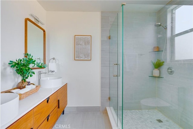 712 N Chestnut Ave, Los Angeles, CA 90042 - bathroom featuring a shower stall, double vanity, baseboards, and tile patterned flooring