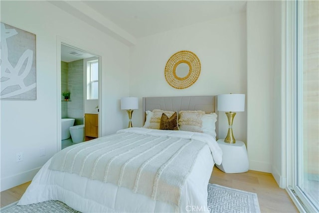 712 N Chestnut Ave, Los Angeles, CA 90042 - bedroom with wood finished floors, multiple windows, and baseboards