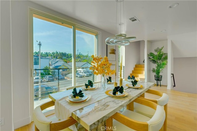 712 N Chestnut Ave, Los Angeles, CA 90042 - dining area with light wood-style flooring and stairs