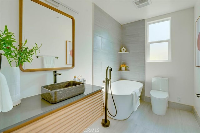 712 N Chestnut Ave, Los Angeles, CA 90042 - full bathroom featuring a freestanding tub, toilet, and vanity
