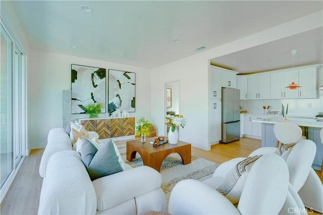 712 N Chestnut Ave, Los Angeles, CA 90042 - living room featuring light wood-style floors and baseboards