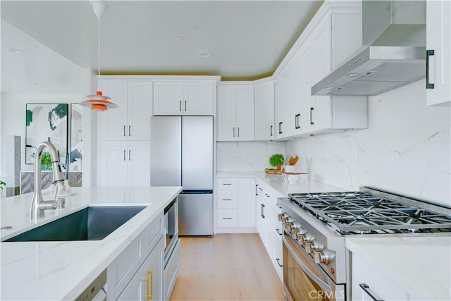 712 N Chestnut Ave, Los Angeles, CA 90042 - kitchen with wall chimney exhaust hood, stainless steel built in refrigerator, a sink, white cabinetry, and light stone countertops