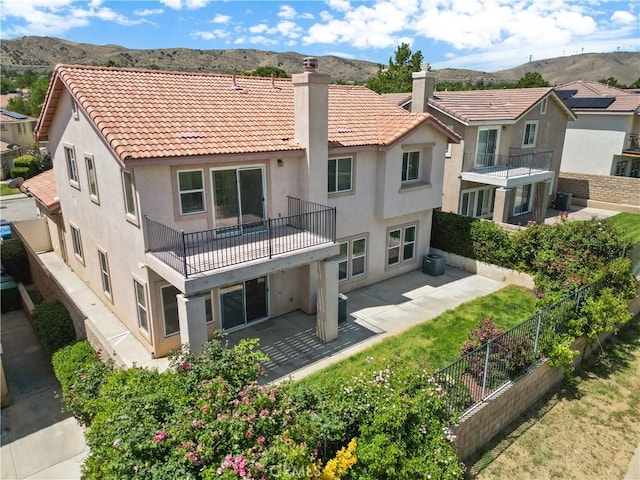 4349 Bethpage Dr, Palmdale, CA 93551 - back of property with a balcony, stucco siding, a mountain view, and a patio