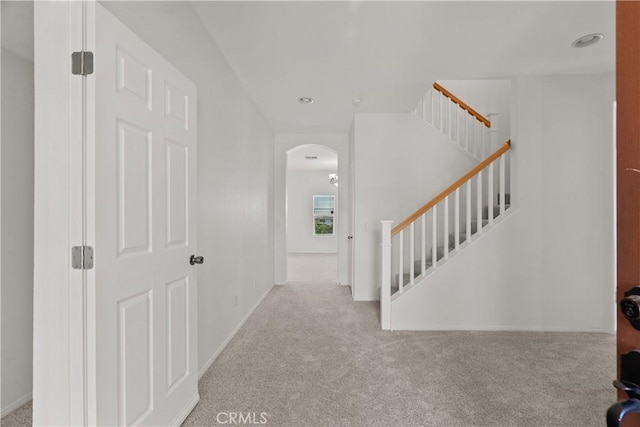 4349 Bethpage Dr, Palmdale, CA 93551 - foyer with carpet flooring, arched walkways, stairs, and baseboards