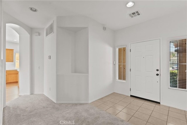 4349 Bethpage Dr, Palmdale, CA 93551 - foyer featuring arched walkways, recessed lighting, light tile patterned floors, and baseboards
