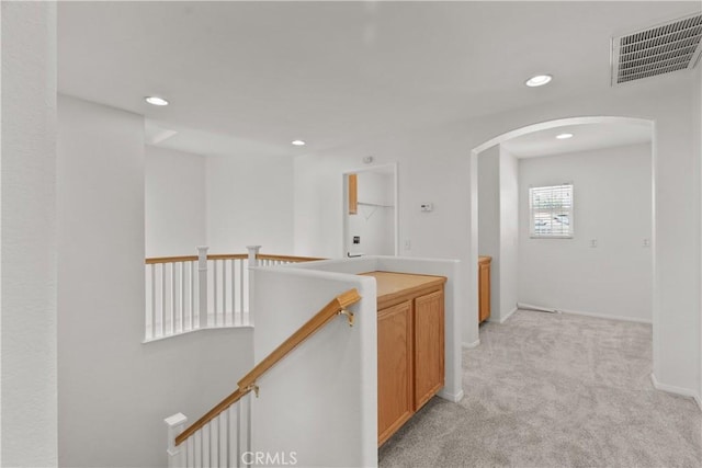 4349 Bethpage Dr, Palmdale, CA 93551 - corridor featuring an upstairs landing, arched walkways, light colored carpet, recessed lighting, and baseboards