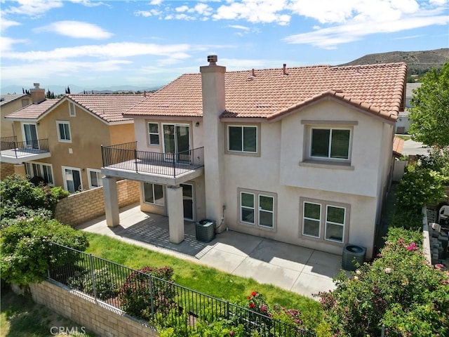 4349 Bethpage Dr, Palmdale, CA 93551 - back of property with a balcony, a chimney, stucco siding, a fenced backyard, and a tile roof