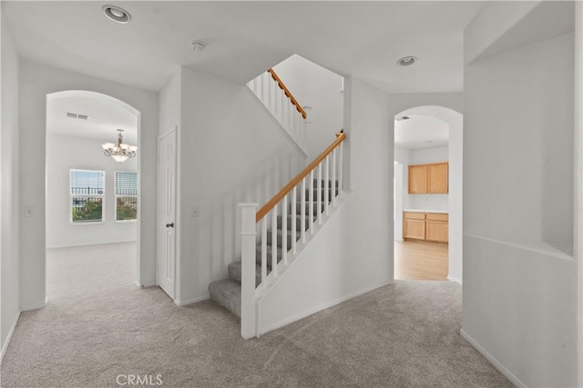4349 Bethpage Dr, Palmdale, CA 93551 - stairs with arched walkways, carpet, a chandelier, recessed lighting, and baseboards