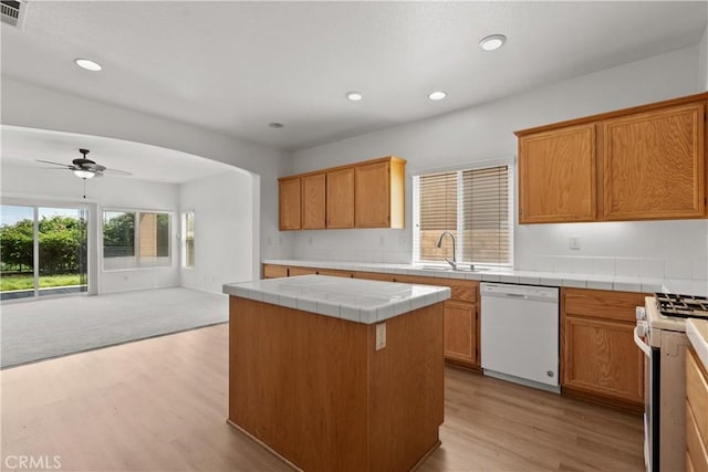 4349 Bethpage Dr, Palmdale, CA 93551 - kitchen featuring white appliances, tile countertops, light wood-style floors, ceiling fan, and open floor plan